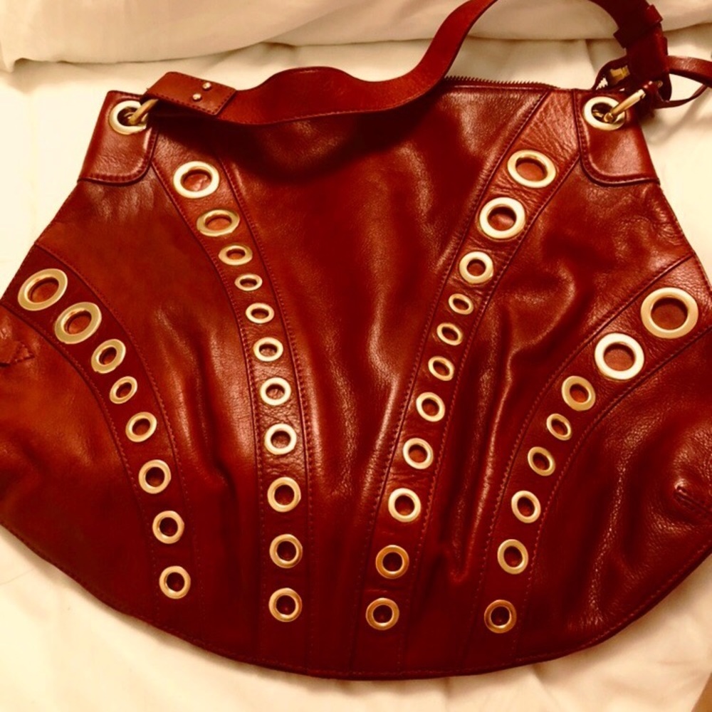 Cole Haan dark red grommet handbag